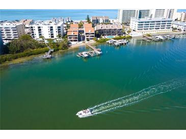 Aerial view of waterfront property with private boat docks and access to the Gulf at 19937 Gulf Blvd # B-3, Indian Shores, FL 33785