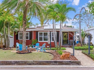 Charming red home featuring a cozy front yard with Adirondack chairs around a fire pit at 238 31St N Ave, St Petersburg, FL 33704