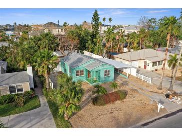 Charming single-story home with a quaint porch and a well-maintained yard with mature trees, offering curb appeal at 266 44Th Ave, St Pete Beach, FL 33706