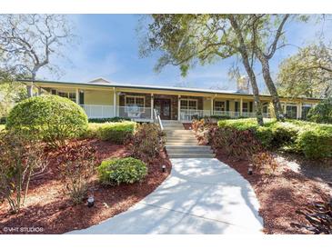 Charming single-story home with landscaped front yard and inviting porch at 2660 Powell Ln, Tarpon Springs, FL 34688