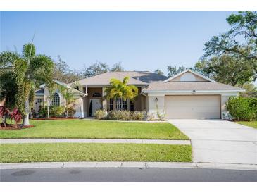 Charming single Gathering home featuring a well-maintained lawn, inviting entrance, and a two-car garage at 3212 Kilmer Dr, Plant City, FL 33566