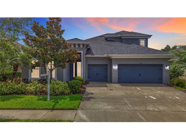 Stunning two-story home featuring a three-car garage and meticulously landscaped front yard at 6527 Mayport Dr, Apollo Beach, FL 33572