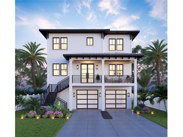 Two-story home with a two-car garage, balcony, front yard with landscaping, and a charming staircase on the left side at 2519 N Riverside Dr, Tampa, FL 33602