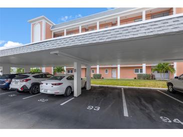 Covered parking area with designated parking spots in front of a well-maintained building at 6800 20Th N Ave # 309, St Petersburg, FL 33710