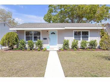 Charming home with a light blue door, healthy green bushes, and a well-maintained front yard at 867 50Th N Ave, St Petersburg, FL 33703