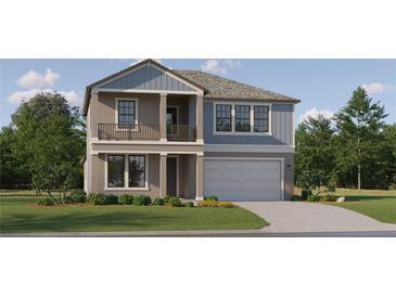 Charming two-story home with gray and blue siding, a two-car garage, and landscaped front yard at 9296 Gladsome Dr, Land O Lakes, FL 34637
