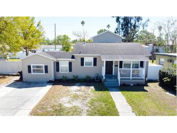 Charming single-story home with a welcoming front porch and well-maintained landscaping at 210 83Rd N Ave, St Petersburg, FL 33702