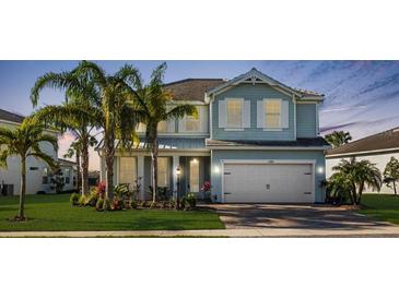 Charming two-story home with a two-car garage, lush lawn and decorative palm trees at 3248 Anchor Bay Trl, Bradenton, FL 34211