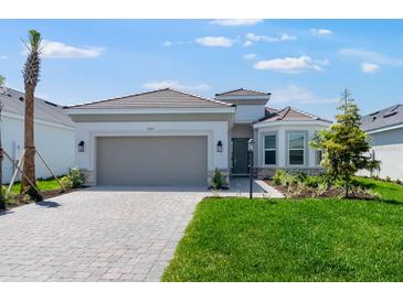 Beautiful one story home features a two car garage, landscaping and brick driveway at 3563 Santa Caterina Blvd, Bradenton, FL 34211
