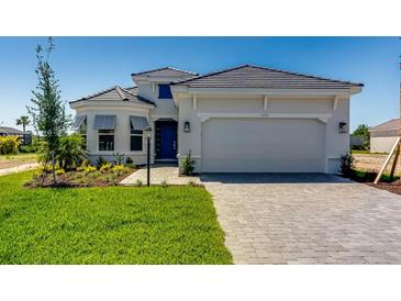 Beautiful single-Gathering home with a well-manicured lawn and paved driveway leading to an attached two-car garage at 3575 Santa Caterina Blvd, Bradenton, FL 34211