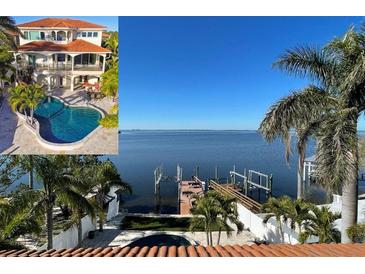 Luxury home showcasing a stunning waterfront view, pool, patio, and private dock at 100 Driftwood W Dr, Palm Harbor, FL 34683