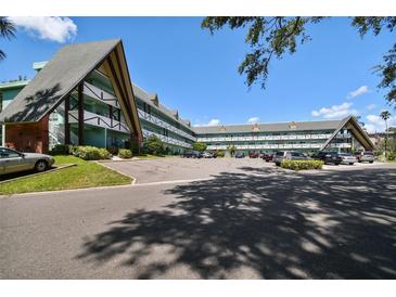 Unique condo complex with manicured landscaping and plenty of parking on a sunny day at 2042 Australia W Way # 6, Clearwater, FL 33763