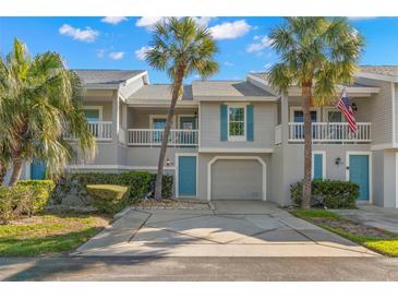 Charming townhouse with two stories, lush landscaping, and an inviting, private entrance with an attached garage at 238 Sun Ketch Ct # 95, Treasure Island, FL 33706