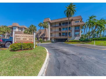 Beautiful Brynnwood community building featuring mature landscaping and a private entry drive at 3021 Countryside Blvd # 23A, Clearwater, FL 33761