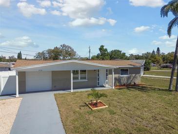 Aerial view of the residence showcasing its well-manicured lawn and neighborhood at 4733 Bonton Dr, Holiday, FL 34690