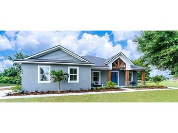 Charming single-story home features a covered porch and well-manicured lawn at 901 Eagle Ln, Apollo Beach, FL 33572