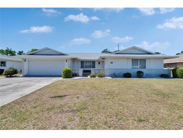 Charming single-story home featuring a manicured front yard and an attached garage, offering both curb appeal and convenience at 1508 W Del Webb Blvd, Sun City Center, FL 33573