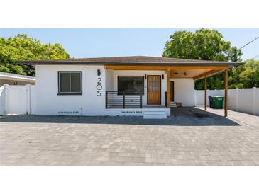 Charming single-story home featuring a modern design with a quaint front porch and updated landscaping at 205 N Macdill Ave, Tampa, FL 33609