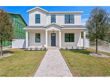 Charming two-story home with a well-manicured lawn and inviting brick pathway at 1239 36Th N Ave, St Petersburg, FL 33704