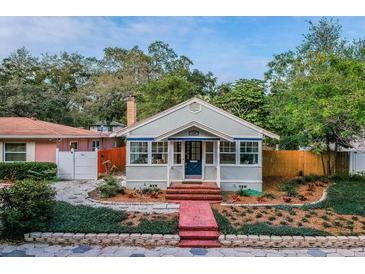 Charming bungalow with brick pathway, covered porch, and mature landscaping in the front yard at 129 18Th N Ave, St Petersburg, FL 33704