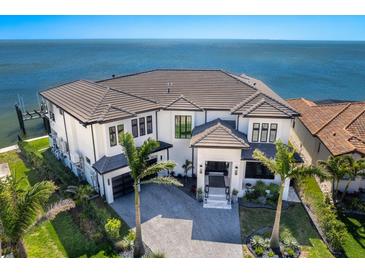 Stunning waterfront home featuring manicured landscaping, a circular driveway, and a modern design at 1906 Carolina Ne Ave, St Petersburg, FL 33703