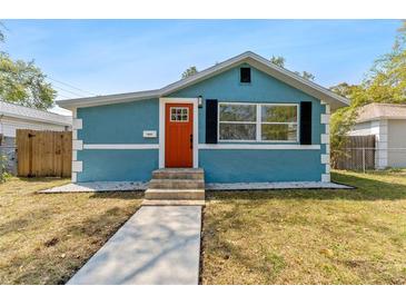 Charming blue bungalow with a bright orange front door and manicured landscaping at 1941 48Th S St, St Petersburg, FL 33711