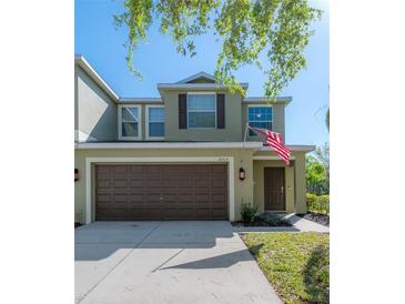 Charming two-story home featuring a two-car garage, well-maintained lawn, and traditional architectural details at 20319 Starfinder Way, Tampa, FL 33647