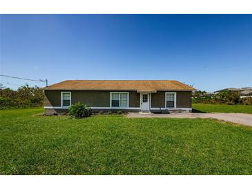 Charming one-story home featuring a well-maintained lawn and a classic, welcoming exterior at 10603 1St St, Riverview, FL 33569
