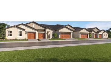 Charming street view of newly built homes, each with a neat lawn and a private two-car garage at 10608 Gable Dig Loop, San Antonio, FL 33576