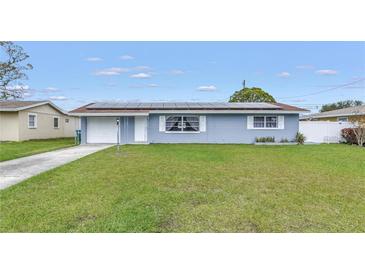 Charming home featuring solar panels, a well-manicured lawn, and an attached one-car garage at 11973 80Th Ave, Seminole, FL 33772