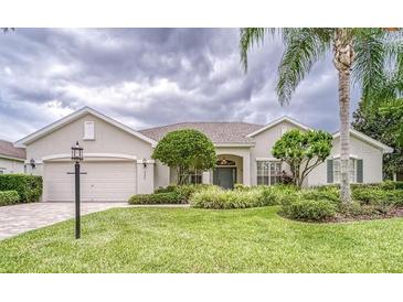 Charming single-story home featuring a well-manicured lawn and lush landscaping at 2926 Spring Hammock Dr, Plant City, FL 33566