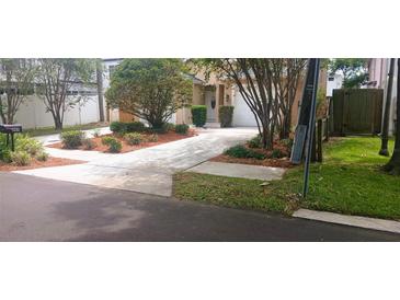 Well-maintained home with fresh landscaping, healthy lawn, and inviting driveway at 409 S Arrawana Ave, Tampa, FL 33609