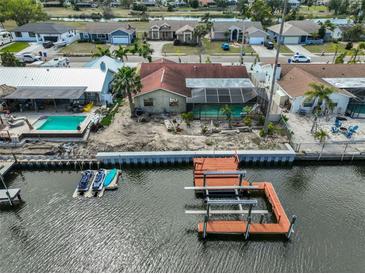 Waterfront home with boat dock and lift, screened lanai, and pool offers perfect outdoor living and canal access at 727 Flamingo Dr, Apollo Beach, FL 33572