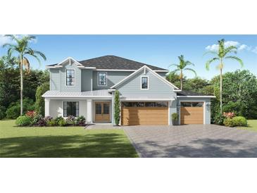 Charming two-story home with a three-car garage, beautiful landscaping, and a well-maintained lawn at 3904 W Vasconia St, Tampa, FL 33629