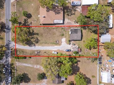 Aerial view of property with a large lot, mature trees, and a driveway at 4020 Amber Rd, Valrico, FL 33594