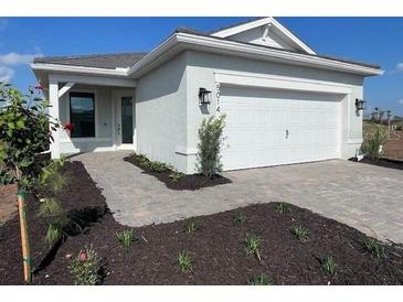 Beautiful single-story home featuring a two-car garage and well manicured landscaping at 5014 Coastal Oak Ct, Lakewood Ranch, FL 34211