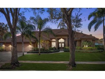 Beautiful single-story home featuring lush landscaping, a well-manicured lawn, and a charming front entrance at 7226 Bryce N Pt, Pinellas Park, FL 33782