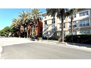 Charming street view of condo building with palm trees at 2320 W Azeele St # 317, Tampa, FL 33609