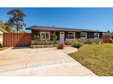 Charming single-story home with a well-maintained lawn, beautiful landscaping, and a welcoming front entrance at 8871 94Th St, Seminole, FL 33777