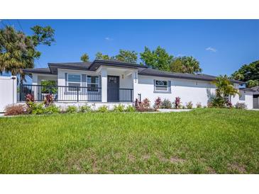 Charming single-story home featuring a freshly landscaped front yard and inviting front porch at 1102 N Albany Ave, Tampa, FL 33607