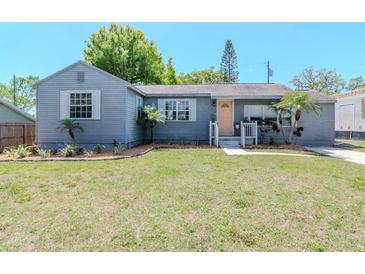 Charming single-story home featuring a well-maintained lawn and a welcoming, light-orange front door at 1528 W River Shore Way, Tampa, FL 33603