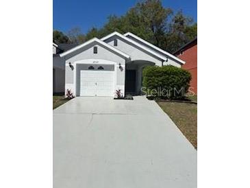 Charming single-story home with well-manicured landscaping and a two-car garage at 28549 Seashell Ct, Wesley Chapel, FL 33545