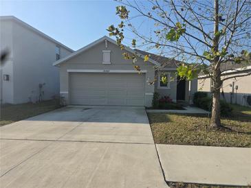 Charming single-Gathering home featuring a two-car garage and well-maintained front yard at 36562 Silver Maize Dr, Dade City, FL 33525