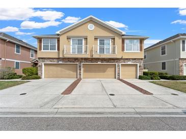 Charming townhome featuring a stone facade, balconies, and three-car garage for ample parking and storage at 555 52Nd N Ave, St Petersburg, FL 33703