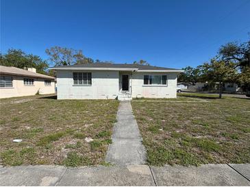 Charming single-story home featuring a concrete walkway leading to the front door and a well-maintained lawn at 801 37Th S Ave, St Petersburg, FL 33705