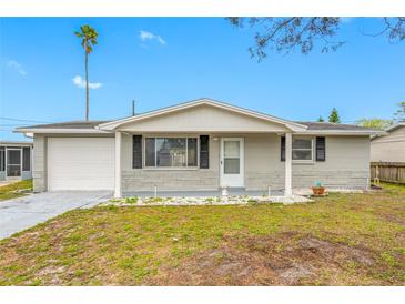 Charming single-story home featuring a front lawn, attached garage, and neutral exterior paint at 10836 Inglewood Ave, Port Richey, FL 34668