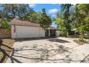Charming single-story home with a two-car garage and well-maintained front yard landscaping and ample parking at 1368 Noell Blvd, Palm Harbor, FL 34683