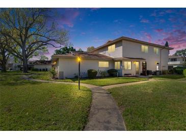 Inviting two-story townhouse featuring a well-manicured lawn, and a charming walkway at 1832 Bough Ave # 3, Clearwater, FL 33760