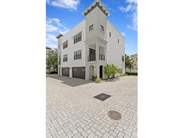 Stunning three-story home with a two-car garage and beautiful architectural details at 224 S Audubon Ave, Tampa, FL 33609
