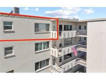 Charming condo building featuring private balconies and patriotic American flag at 4210 Ironwood Cir # 501J, Bradenton, FL 34209
